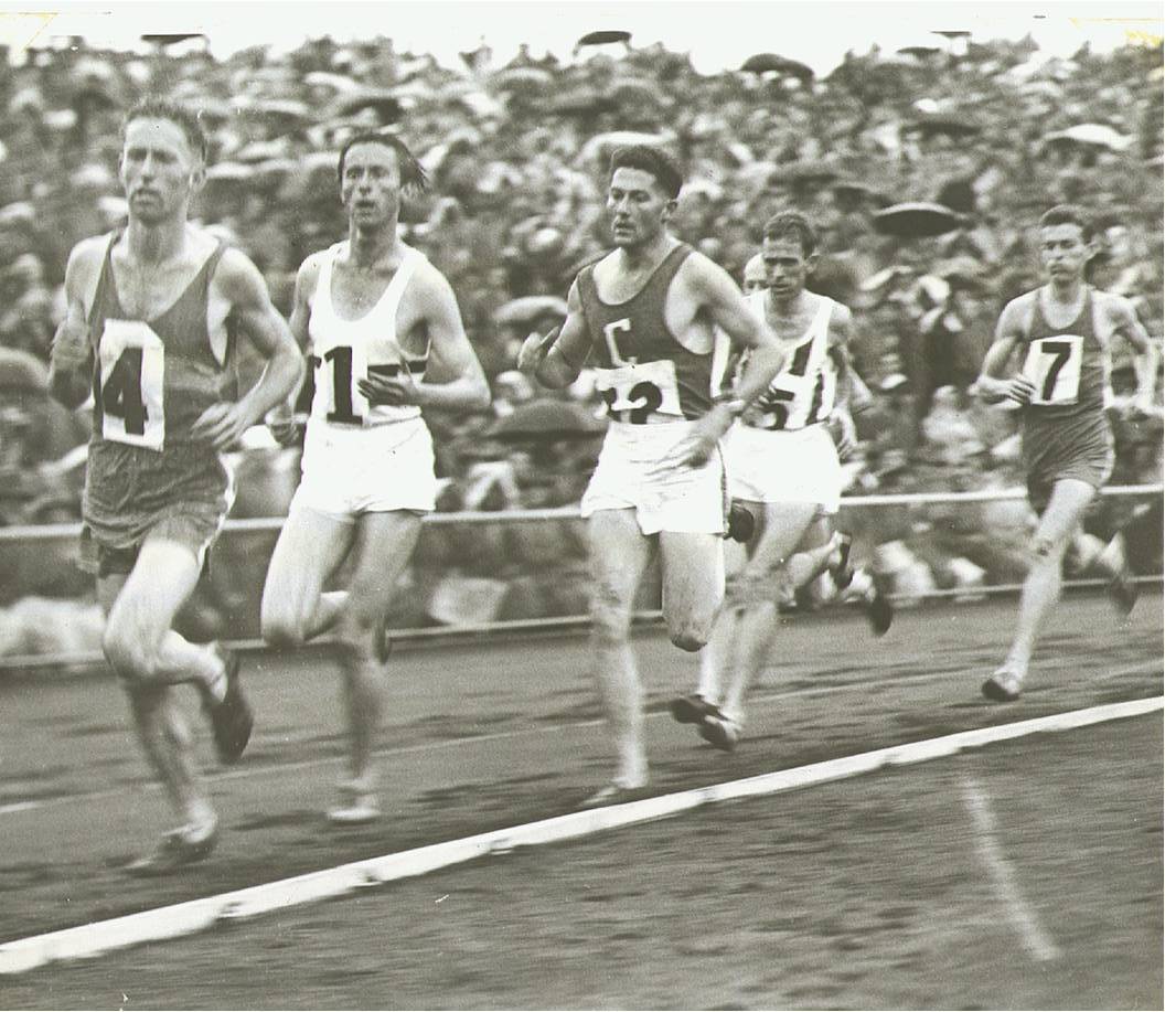 1955 - Hungarian Pre Olympic Meeting 3 Miles Run at Olympic Park
Result: 
1st Dave Stephens - 13 minutes 37.6 seconds
2nd Sandor Iharos - 13 minutes 42.3 seconds
3rd Dave Power - 13 minutes 46.8 seconds

It was hard work all the way for Dave Stephens in the 3 Mile. He took the lead after 1 mile and set a cracking pace for six
laps, then he changed his tactics, dropped back and only shot past to a winning lead with 300 yards to go.

Photo: Dave has just hit the front for the first time and is leading Sandor Iharos (Hungary), Harold Stevens (Coburg), Dave Power (NSW), Les Perry (hidden - Williamstown) and John Pierce (Williamstown)
